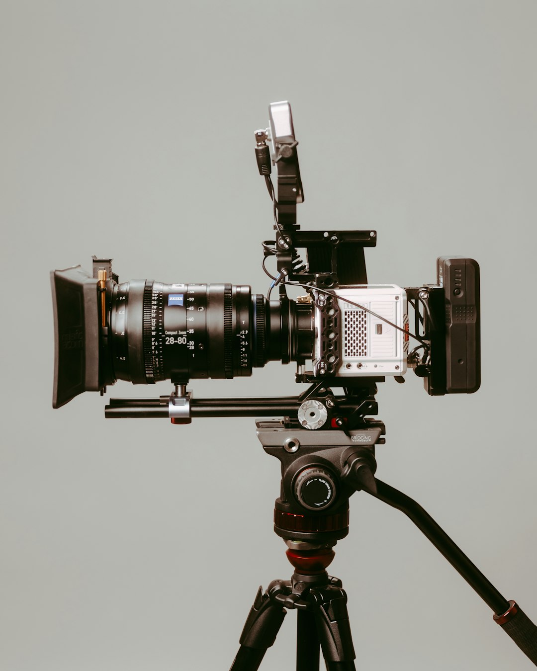 Professional camera on a tripod in a studio setting, the kind of premium gear built by high-end camera makers